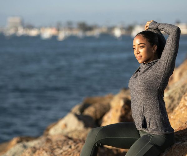 Silhouette of a person stretching during sunrise.